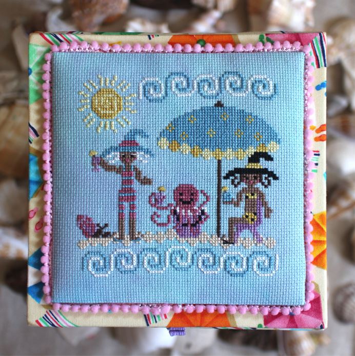 Cross-stitched design of children under an umbrella with a sun, framed by colorful border.