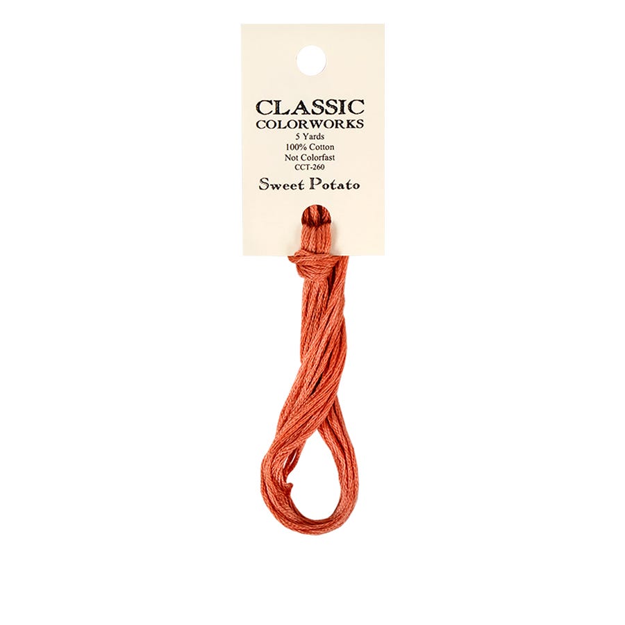 A skein of hand-dyed embroidery floss labeled 'Sweet Potato' color from Classic Colorworks.