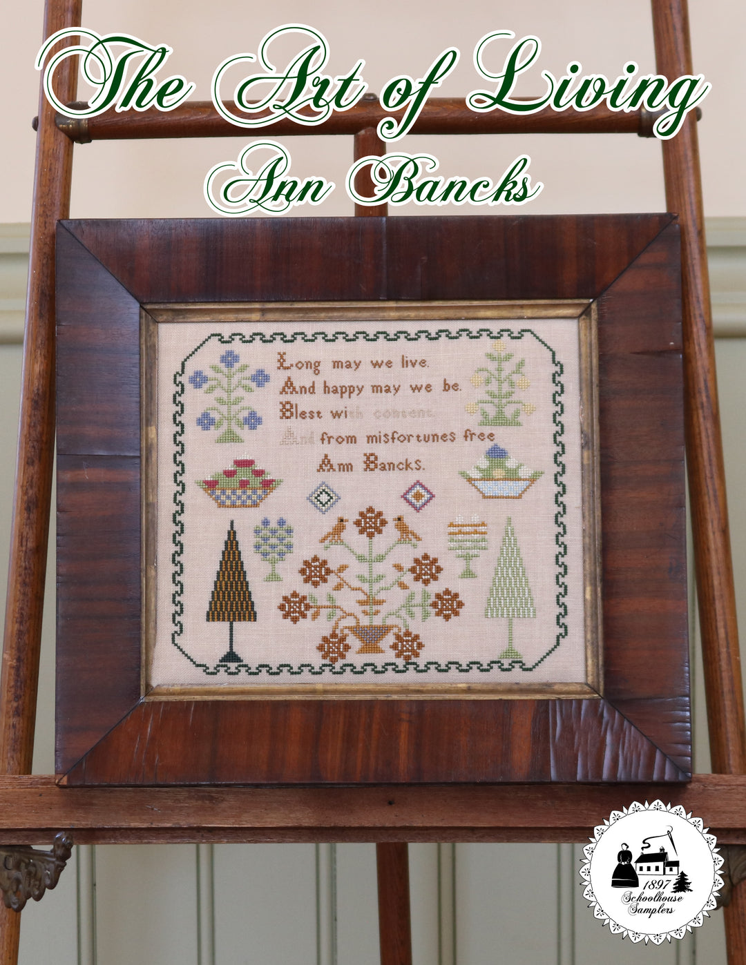 cross stitch sampler featuing text flowers berry baskets  trees and a border
