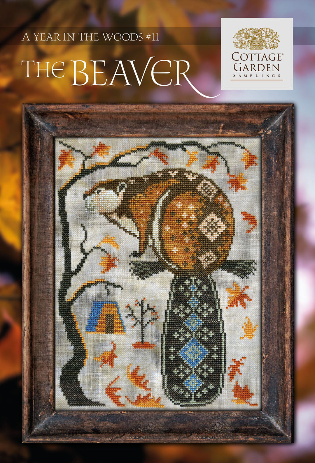 Cross stitch kit depicting a beaver with autumn leaves and a cabin in the woods, titled 'The Beaver, A Year in the Woods #11 | Cottage Garden Samplings'.