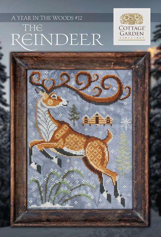 Cross stitch pattern cover for 'The Reindeer' featuring a stylized reindeer design with a Christmas-themed pattern in a wood-like frame.