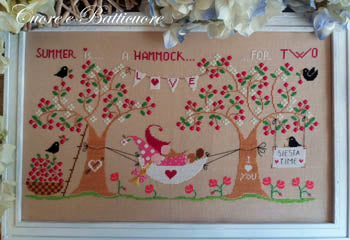 Cross stitch kit depicting a summer-themed scene with a hammock, birds, and flowers, titled 'Summer Is A Hammock For Two'.