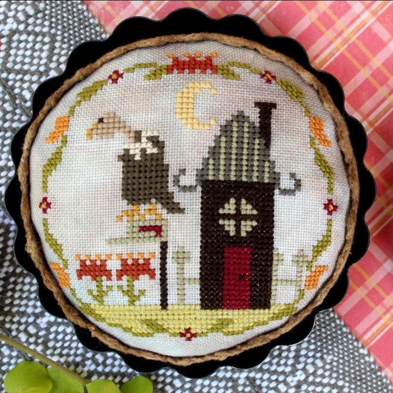 Cross-stitched design of a haunted house with vulture on a textured fabric background, featuring the Lindy Stitches brand.