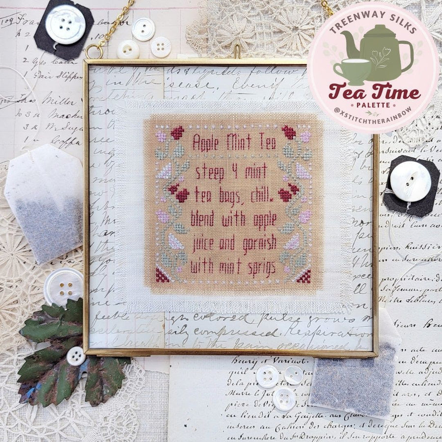 Cross-stitched sampler with text and decorative elements on a textured background
