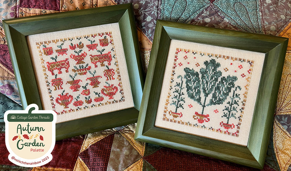 Two framed cross-stitched pieces on a quilted fabric background with 'Autumn Garden Palette' label.
