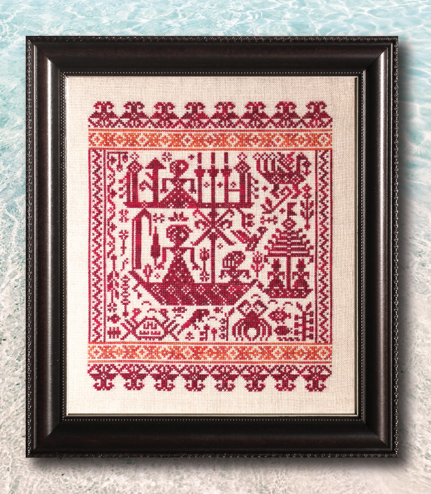 Framed cross-stitched artwork with red patterns on beige fabric