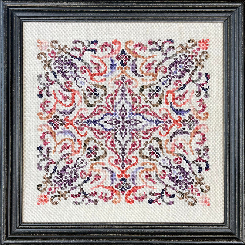 Framed cross-stitched pattern with intricate design on a white background